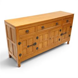 Lizardman - oak 5' sideboard, rectangular top over three panelled frieze drawers, fitted with two double panelled cupboards with wrought iron handles and locks, raised on tapered octagonal feet, with carved lizard signature, by Derek Slater of Crayke