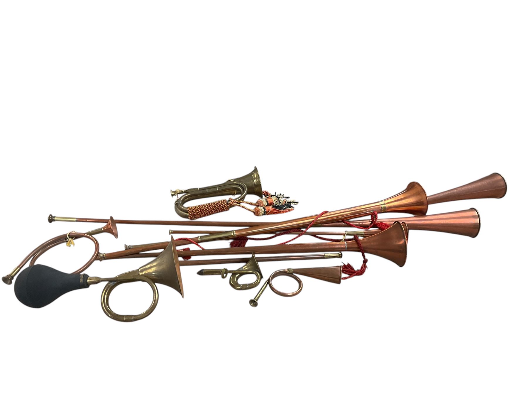 Collection of copper horns, including coaching horns, military bugle etc