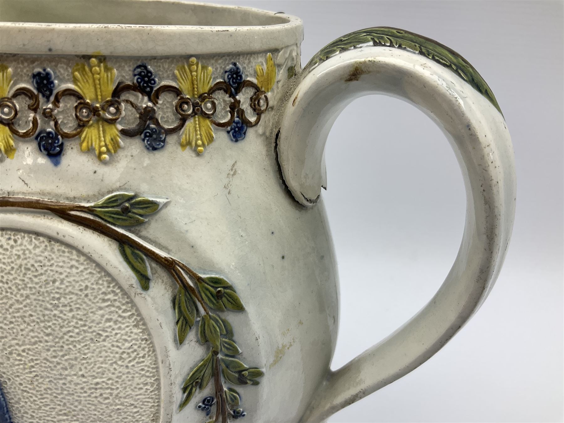 Early 19th century Prattware jug, circa 1800, decorated with two heart shaped panels of children, titled Sportive Innocence and Mischievous Sport, further decorated with acanthus and foliate borders, H22cm