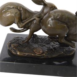 Bronze figure group, modelled as two hares in chase, signed Nick, with foundry mark, upon a rectangular base, H11cm L15cm