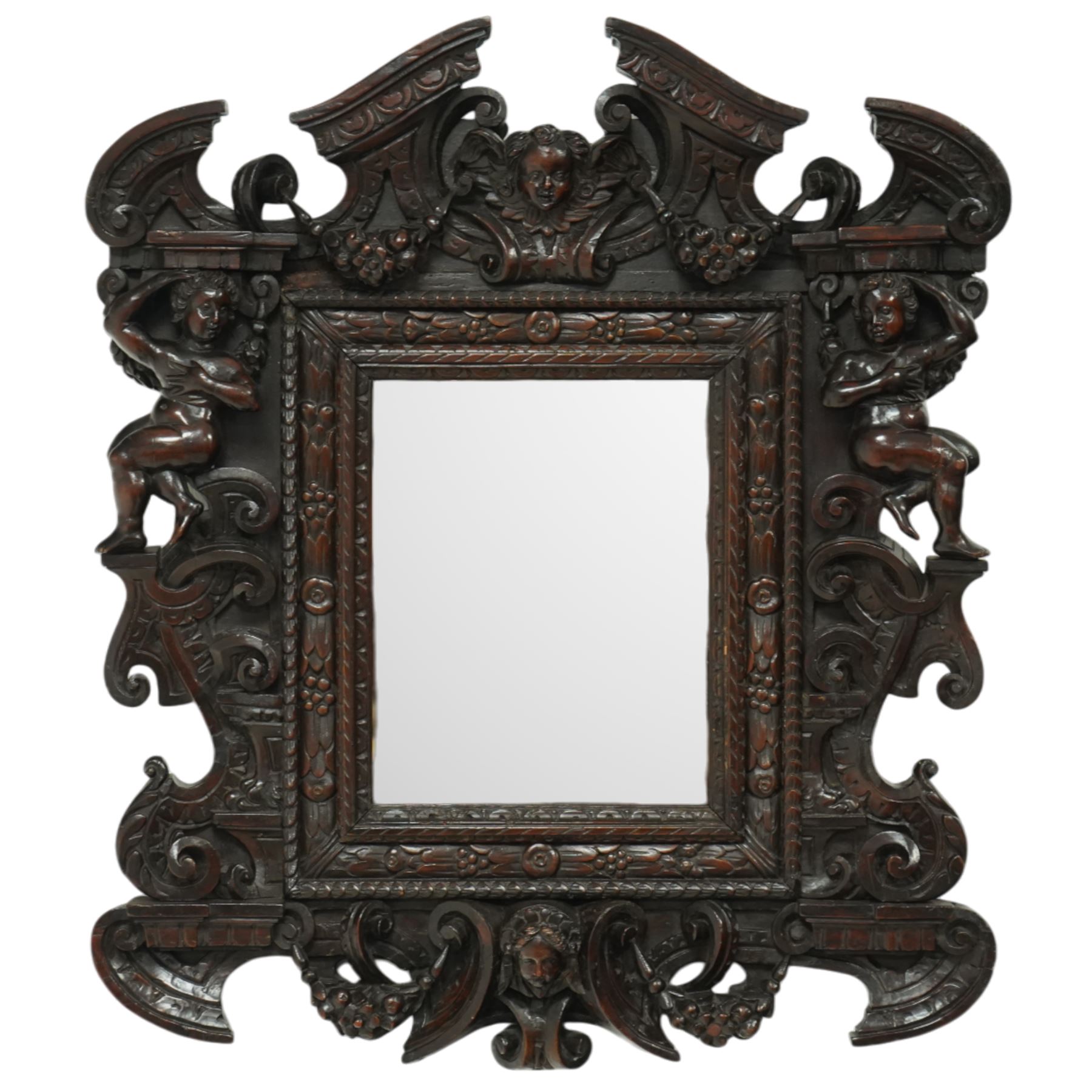 Renaissance-style mid 19th century carved fruitwood wall mirror, carved top surmounted by ‘broken’ arched pediment with central putti figure and grape vine, the sides with two putti figures above C-scroll decorations, and with a similarly carved base