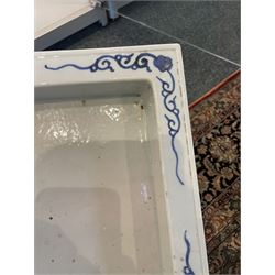 Chinese blue and white planter and stand, each of square slightly tapering and flared form, the planter decorated with two dragons and blossoming peonies, between stylised borders, the stand decorated with flower heads and vines, planter H30cm W29cm, stand H7cm D28.5cm