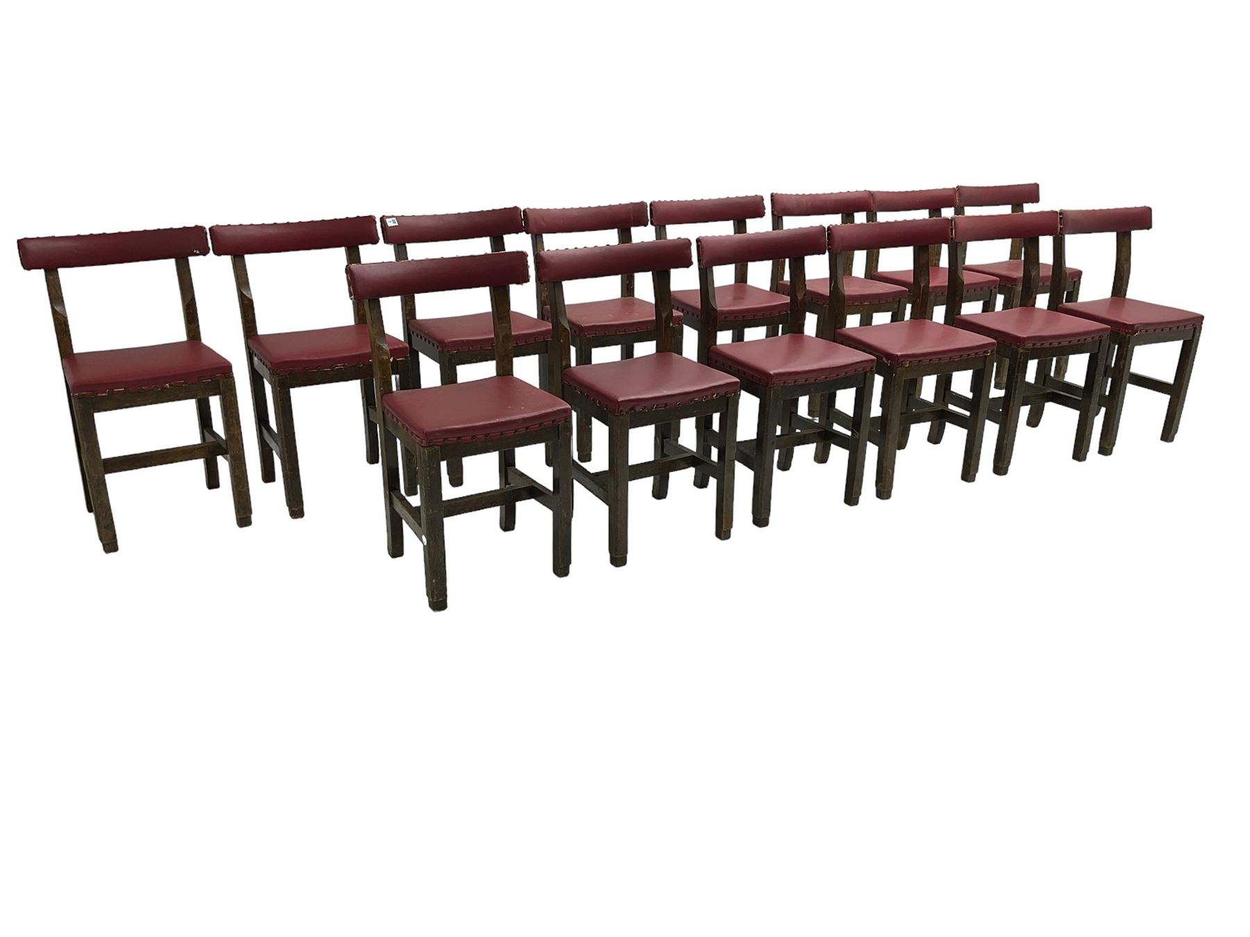 Set fifteen early 20th century oak school chairs, back rail and seat upholstered in claret red faux leather with studwork, raised on square supports united by H-stretcher (15)