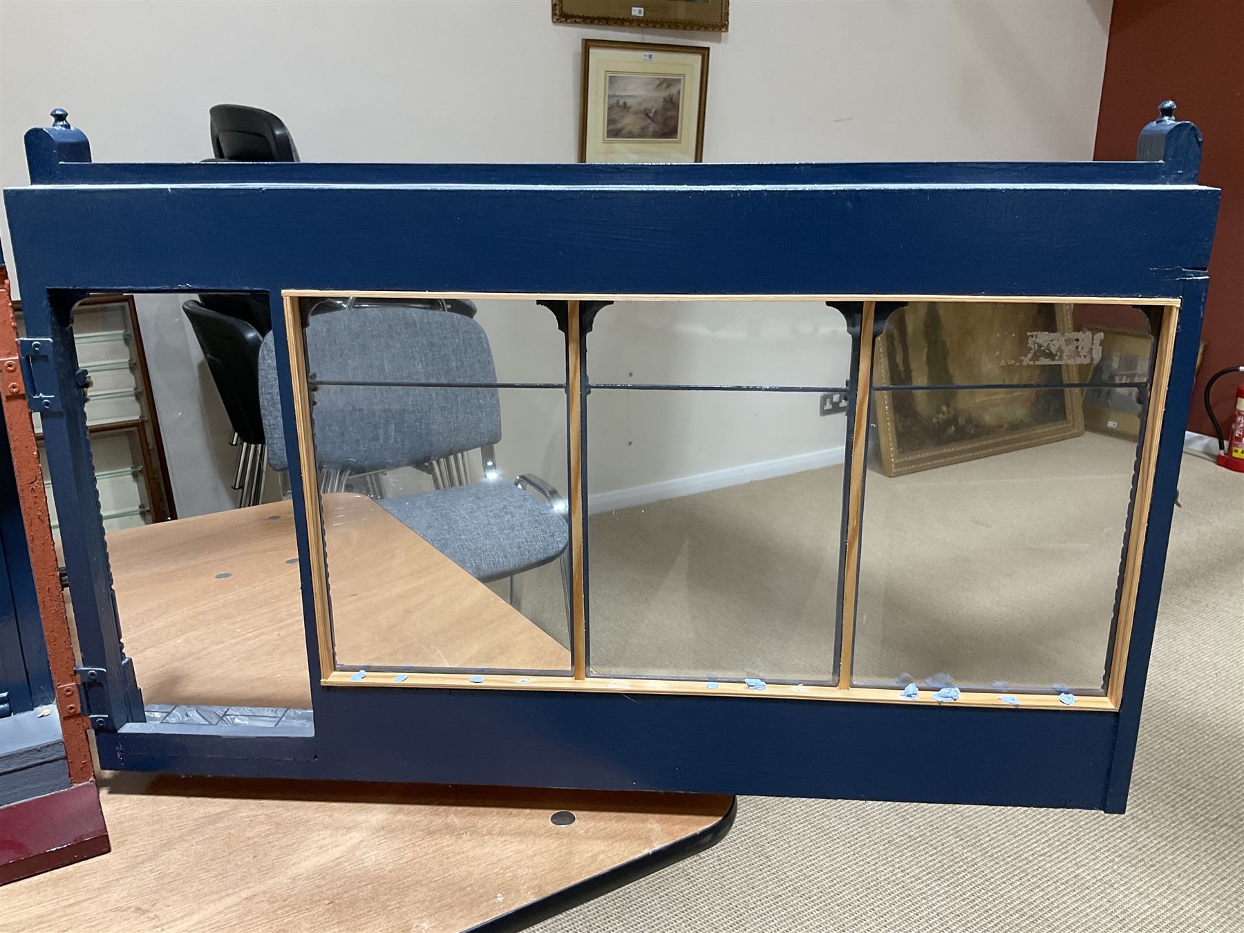 Good quality late 20th century dolls house by M. James dated 1995 in the form of a Beverley East Yorkshire Antique Shop called 'North Bar Antiques'; single-storey single-roomed shop with textured brick walls and flat roof, fully glazed hinged front with recessed hinged customer door and central window to the rear; comprehensively furnished with chests of drawers, pedestal desk, breakfast table, lowboy, two longcase clocks, delft rack with ceramics, occasional tables, pictures, Regency style mirror and collectibles; decorated walls with coving and picture rail and simulated floorboarding; wired for electric lighting; maker's plaque W61cm H42.5cm D41.5cm