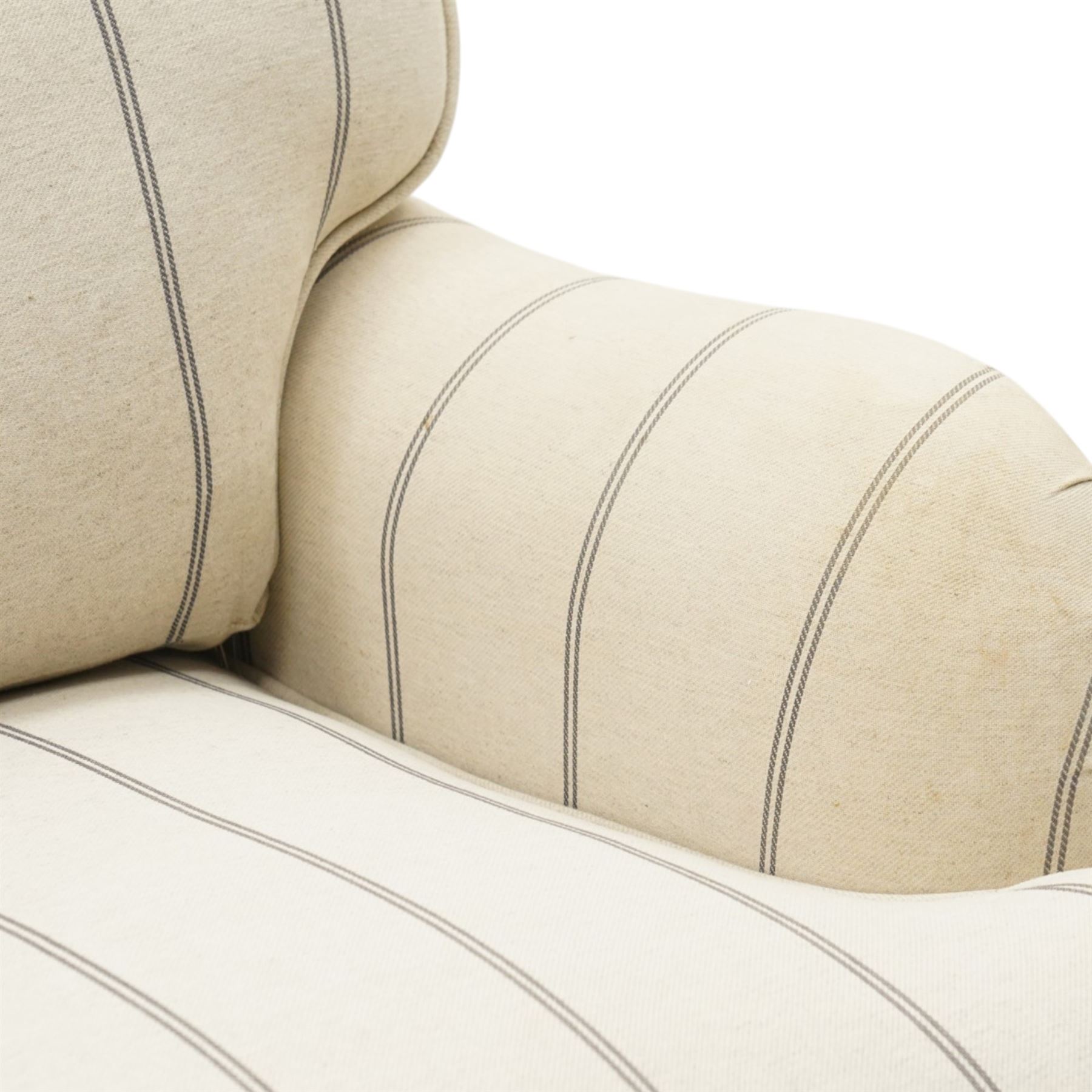 Pair of 20th century Howard shape armchairs, deep seat armchairs in cream and grep striped upholstery, raised on dark supports terminating in front castors