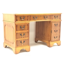  Georgian style Yew wood pedestal desk, three piece inset leather top six drawers, single cupboard, bracket supports, W122cm, H78cm, D61cm  