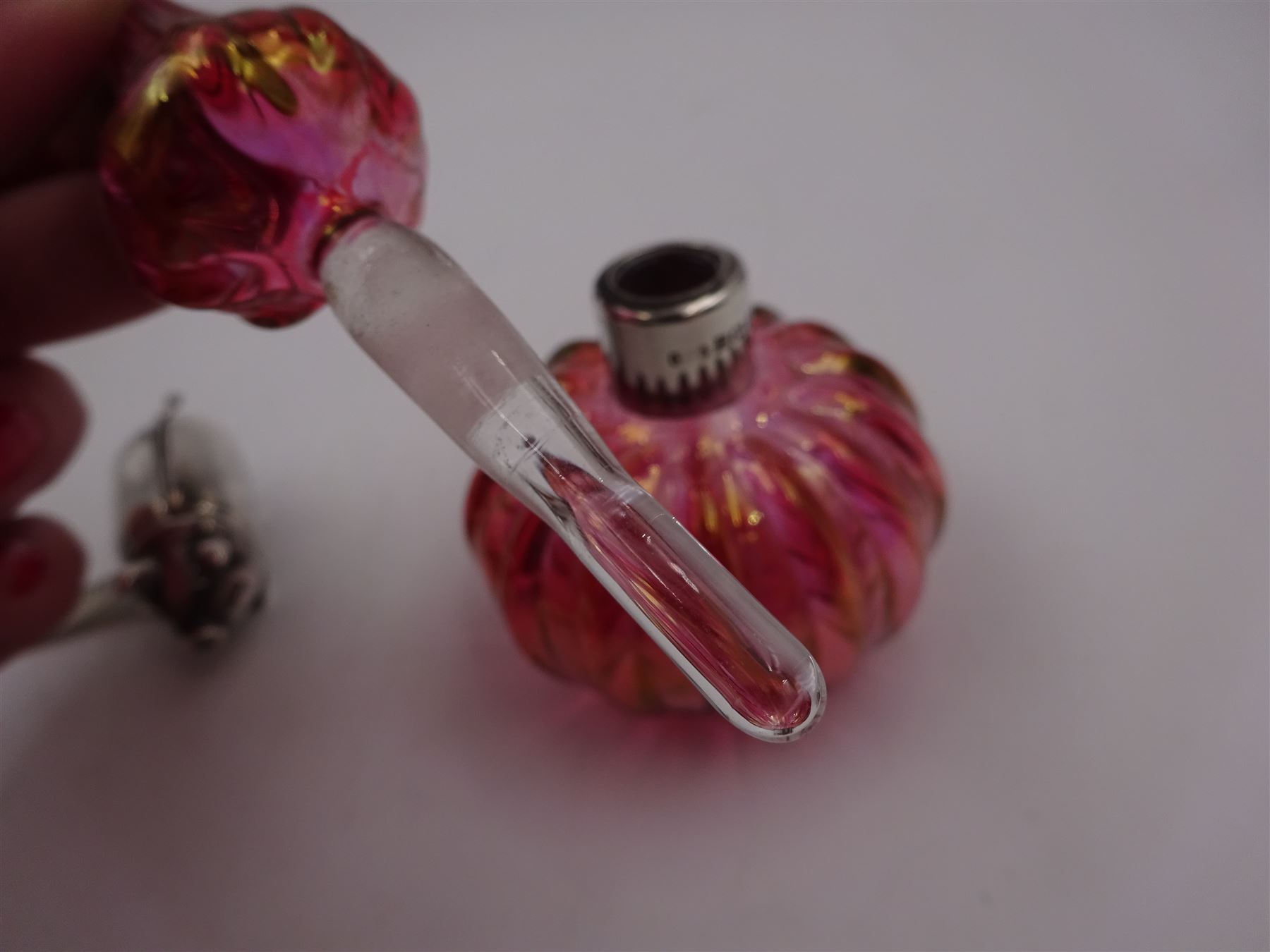 Modern novelty silver tape measure, in the form of a pig, hallmarked CME Jewellery Ltd, together with a silver mounted pink glass scent bottle, signed H. White to base, with silver collar hallmarked Laurence R Watson & Co, Birmingham 1996, scent bottle H12cm