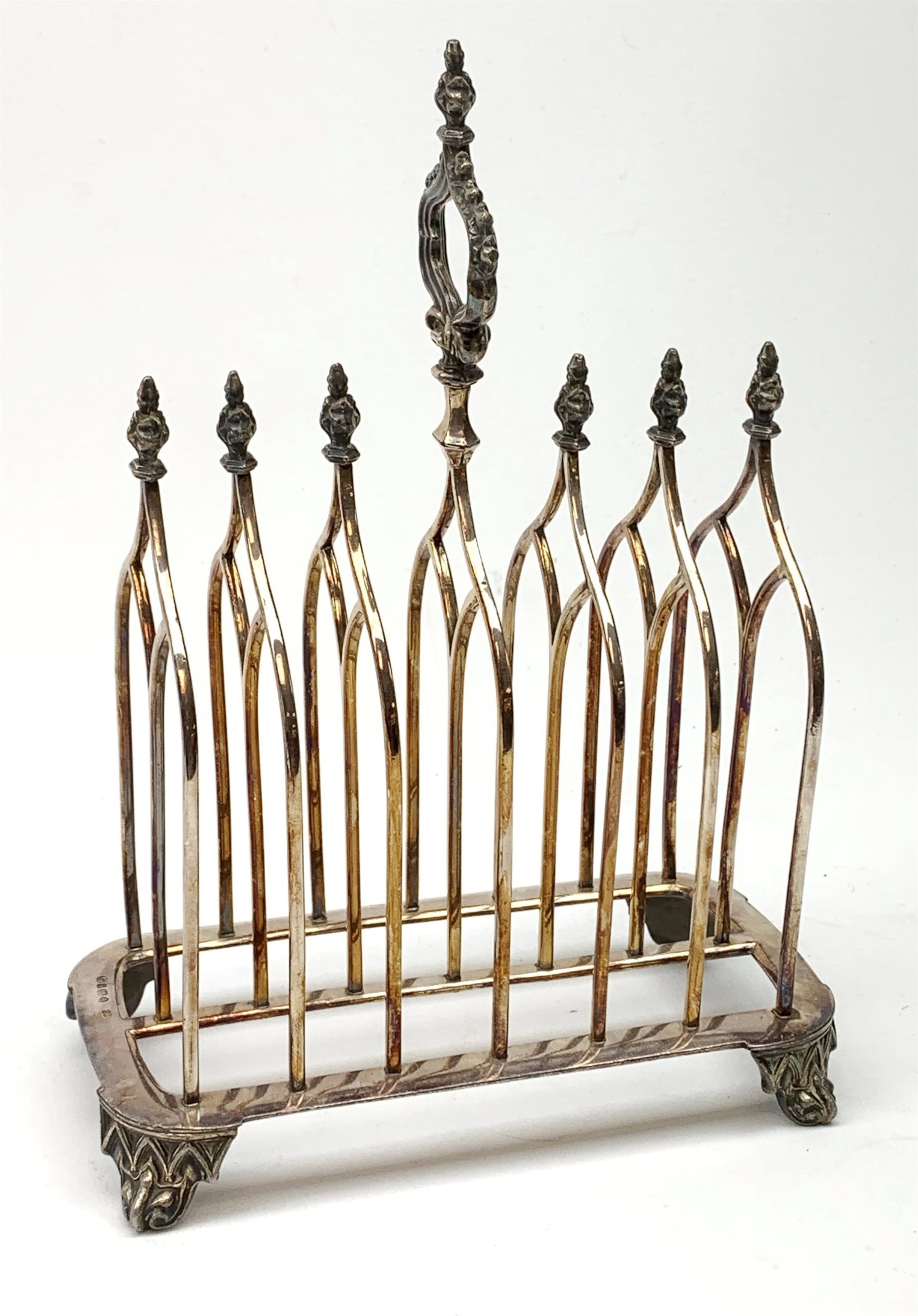 Victorian electroplate Gothic style toast rack, with seven arched bars, openwork handle and arcaded bracket feet, marks for John Gilbert, H25cm   