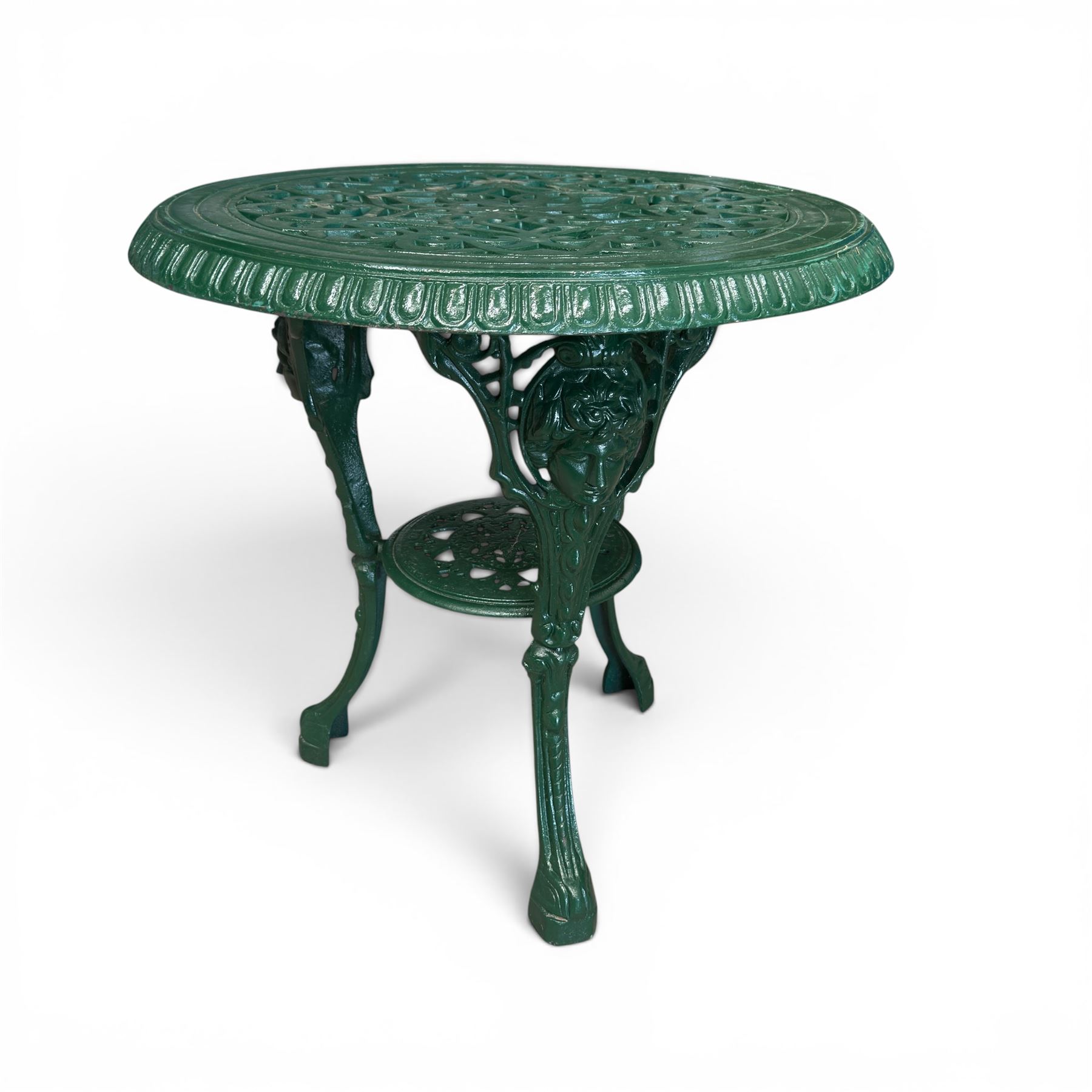 Painted cast iron garden table, the circular pierced top with foliate decoration and egg-and-dart rim, raised on three cloven hoof supports with classical female mask knees, united by pierced undertier, in green-painted finish