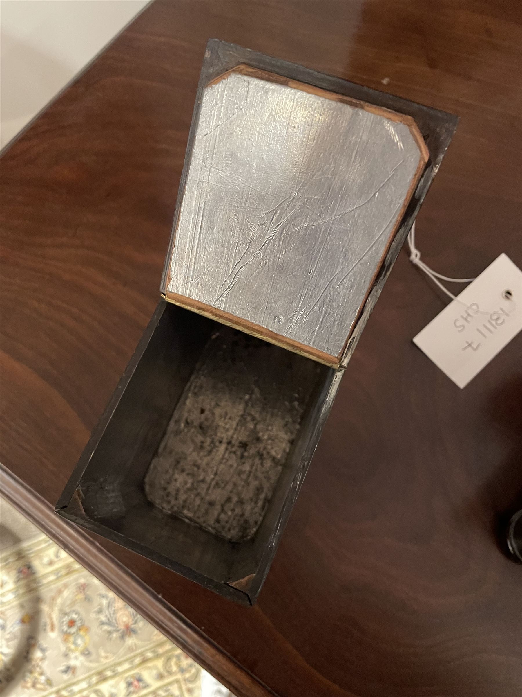 Early 19th century rosewood and brass inlaid tea caddy, of sarcophagus form, the front and hinged opening cover inlaid with brass scrolling panels, opening to reveal a compartmented interior with twin removable boxes with conforming inlaid brass detail to the hinged covers and zinc lining to the interiors, flanking a later glass mixing bowl, the whole upon four turned cylindrical feet, H21cm W36cm D20cm