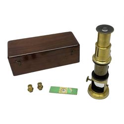 Victorian student's travelling brass monocular microscope H15cm; in fitted mahogany case with two additional lenses and one slide