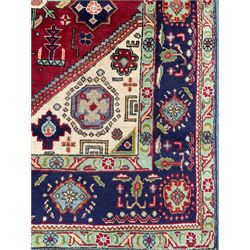 Qashqai red and blue ground rug, with central medallion, green repeating border with geometric motifs 