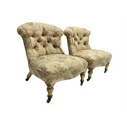 Pair Victorian giltwood nursing chairs, upholstered in buttoned floral pattern fabric, turned front supports on brass castors 