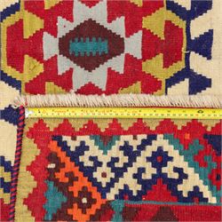 South west Persian Qashqai flatweave kilim, central field with a linked column of hooked diamond medallions in polychrome tones with an ivory lattice on a magenta ground framed by multiple geometric borders 
