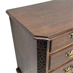 George III Chippendale design mahogany chest, moulded rectangular top with canted corners, wide canted uprights with blind fretwork decoration, two short and three long with moulded fronts, shaped brass handle plates, on ogee bracket feet 