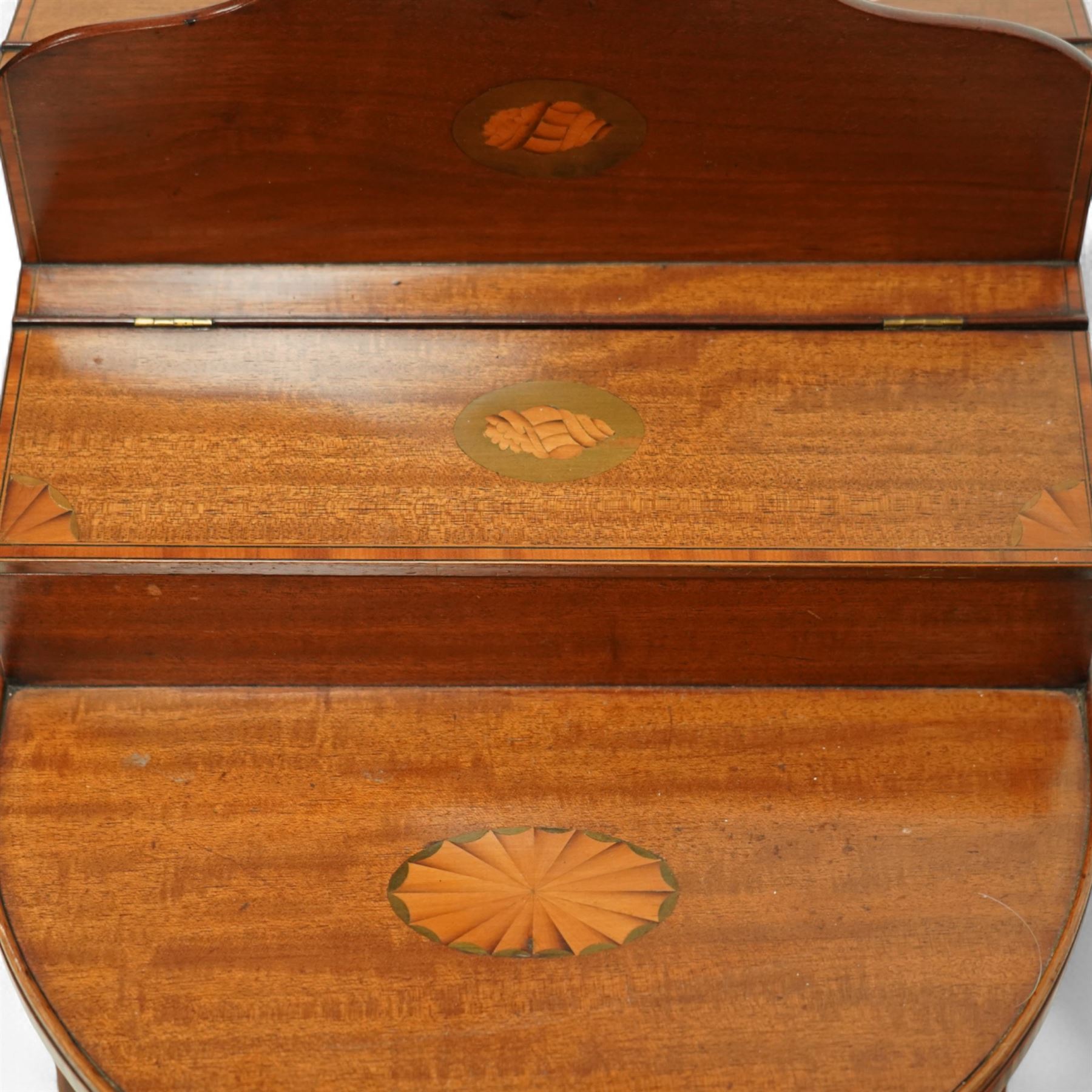 Early 20th century Edwardian mahogany work table, oval top inlaid with satinwood shell motif and stringing, hinged compartment fitted with letter rack and divided interior, on tapering legs with brass castors