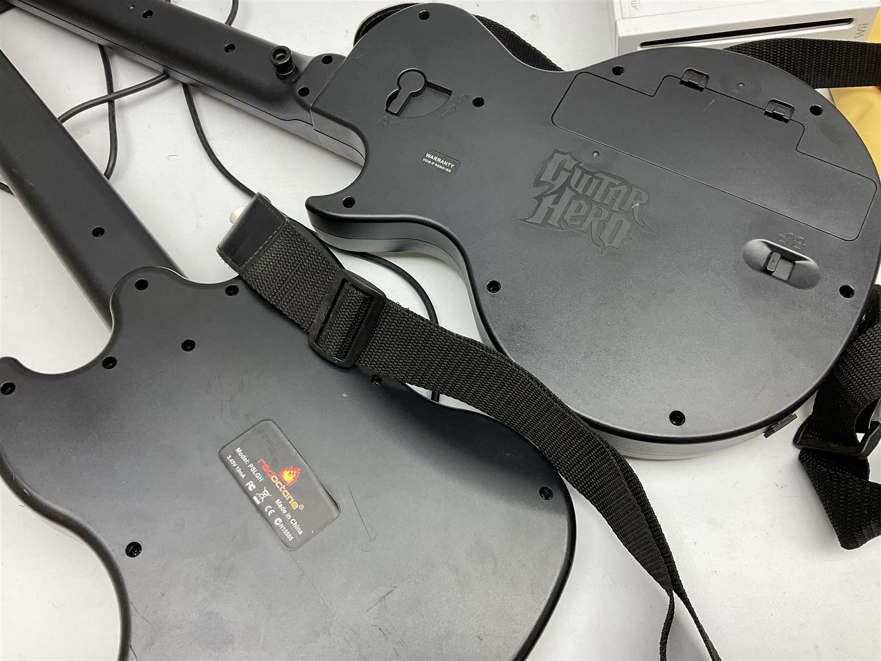 Nintendo Wii console, four controllers with cases and four nunchucks, Wii sensor bar, balance board and dance mat. Guitar hero wireless guitar for Wii and Redoctane wired guitar. Nintendo DS lite handheld gaming console, console and game cases and Guitar Hero Redoctane Guitar Grip. Selection of Nintendo Wii and Nintendo DS lite games to include Super Mario Galaxy, Guitar Hero, Wii Fit, Legend of Zelda games etc. Archos AV400 Series pocket video recorder with accessories, cradle and remote, in three boxes