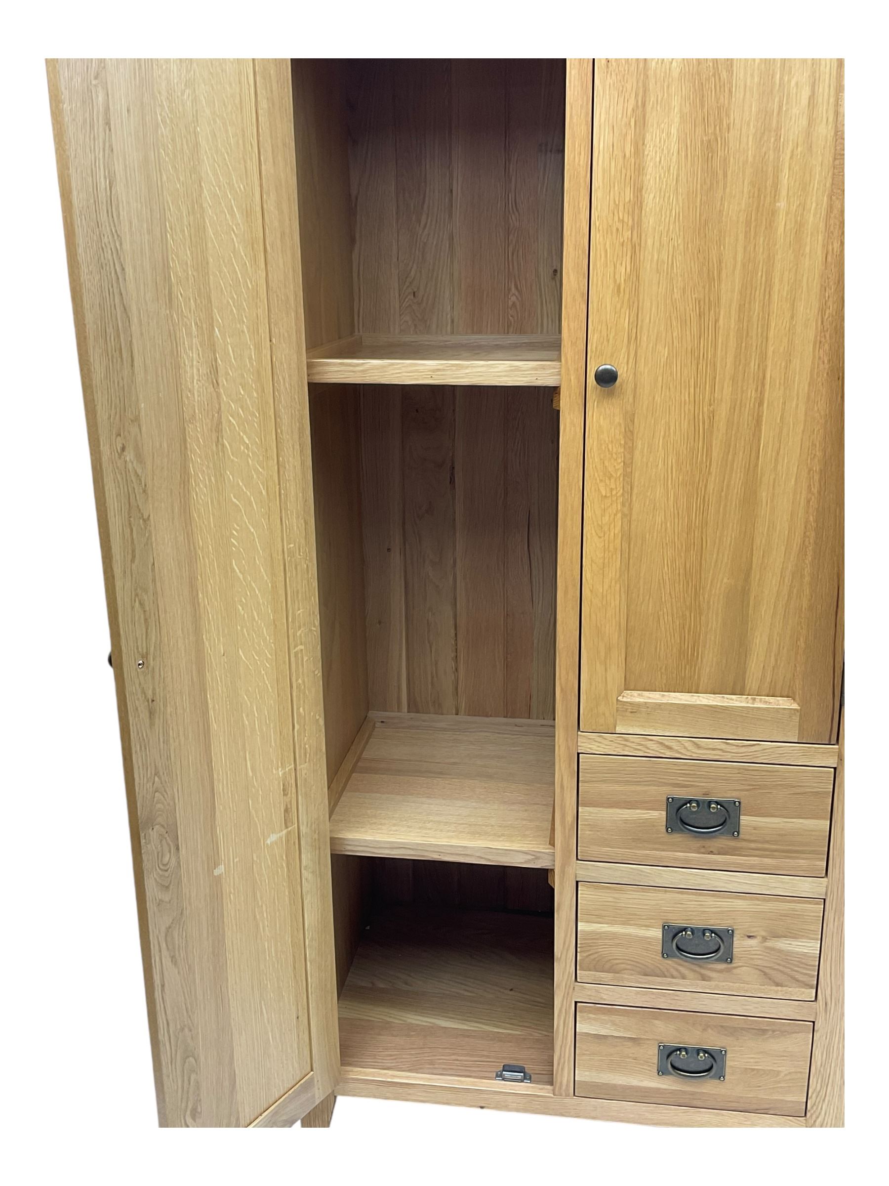 Light oak combination wardrobe, fitted with full-height compartment, single cupboard and three small drawers