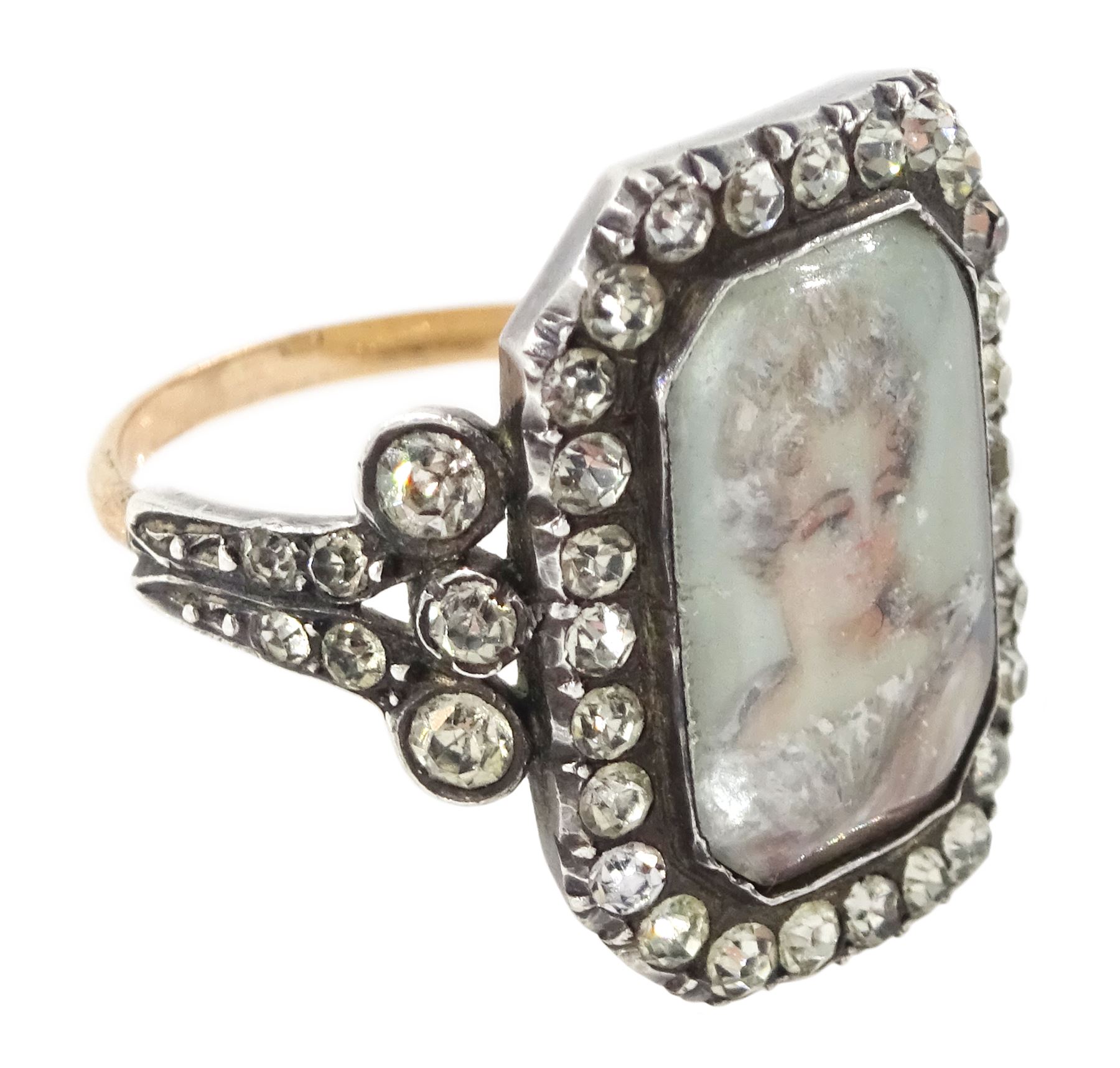 19th century 18ct gold and silver paste set portrait ring, octagonal miniature of a woman on ivory, under a glazed panel, with paste stone surround, to bifurcated paste set shoulders. This lot has been registered for sale under Section 10 of the APHA Ivory Act