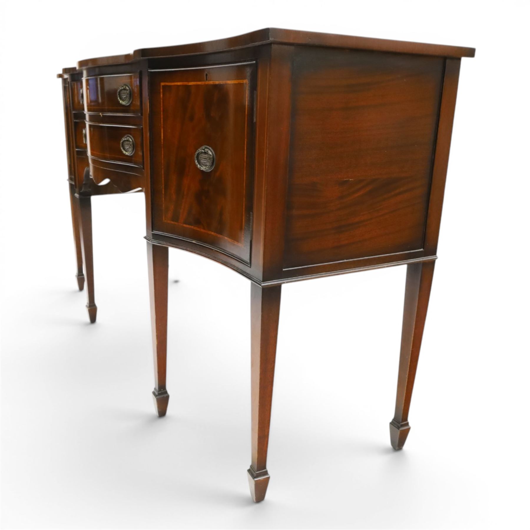 Georgian design mahogany serpentine sideboard, shaped top over two central drawers flanked by cupboard doors, flame mahogany veneered fronts with satinwood stringing, oval brass handles, shaped apron, on square tapering supports with spade feet
