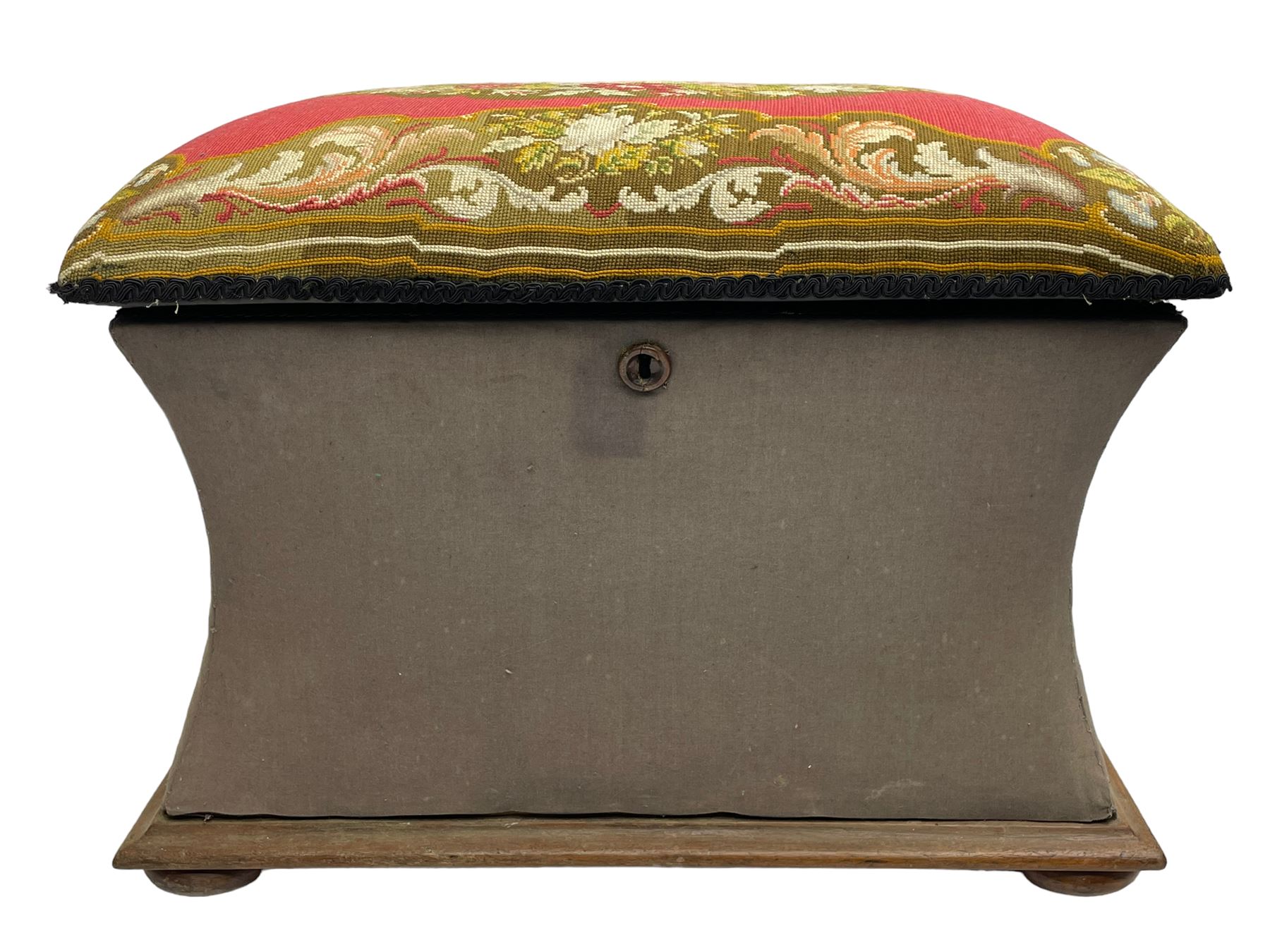 19th century upholstered ottoman, rectangular waisted form with hinged lid, upholstered in needle work cover decorated with floral panels and borders, the interior lined in blue fabric, lower moulded edge over compressed bun feet