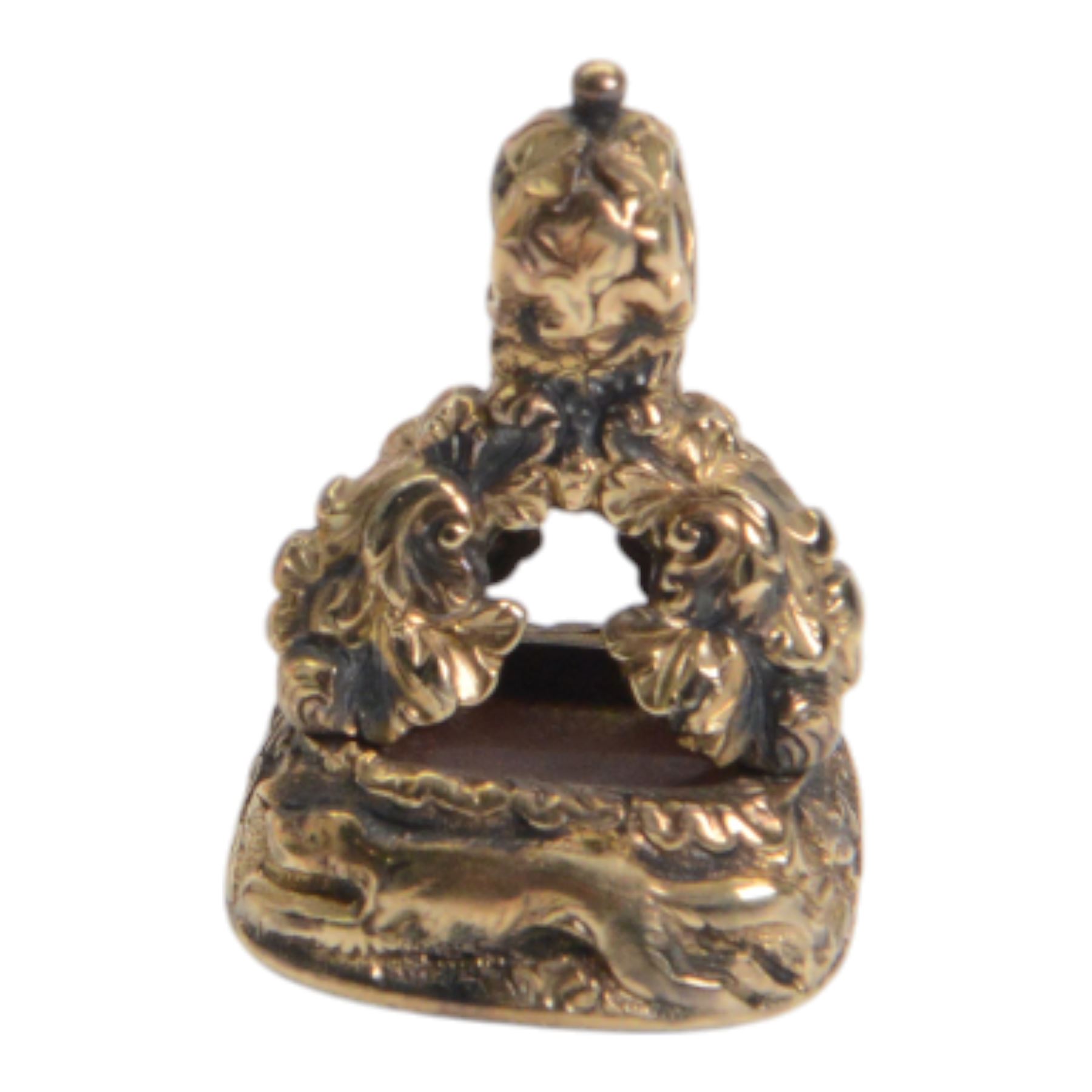 Late 18th/early 19th century 12ct gold fob seal, the carnelian matrix engraved with the Chichester family coat of arms, depicting a chequy shield beneath a crest of a heron with an eel in its beak, within a scrolling foliate mount, the sides detailed with a hound in chase and birds, H3cm

Provenance: By family descent from the Chichesters of Arlington Court, Devon; from the collection of Andrew Chichester Everitt.
