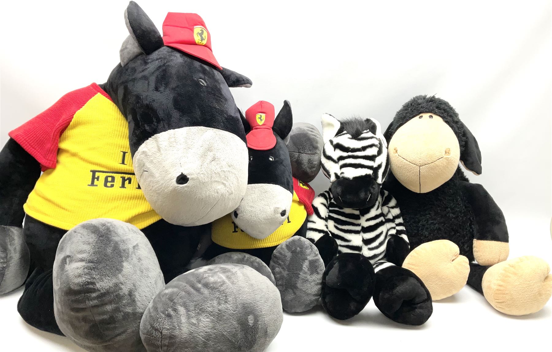 Four large Nici plush toys, comprising of two 'I love Ferrari' horses, with baseball hats, zebra and a black sheep, largest example H115cm 
