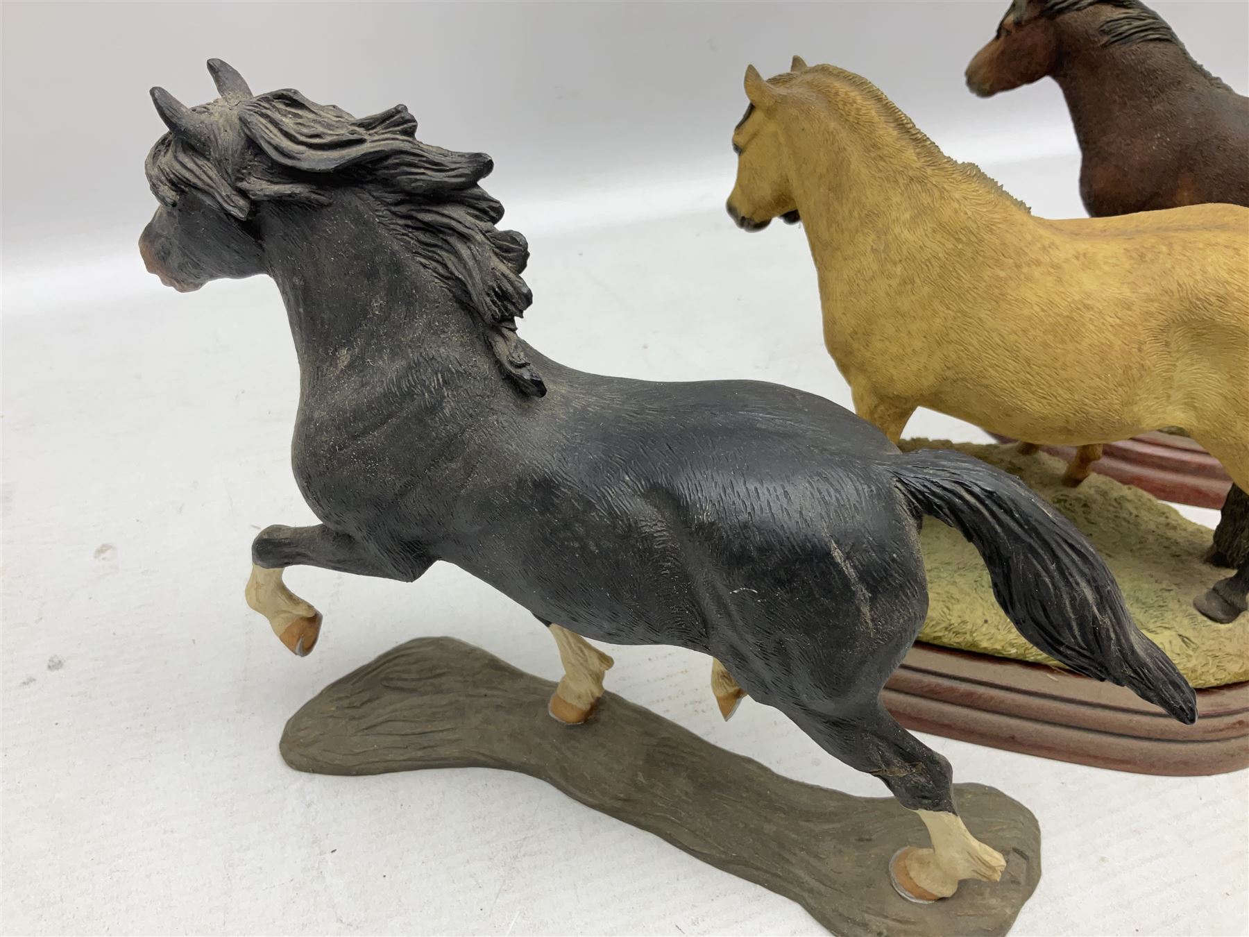 Collection of Border Fine Arts figures, comprising Exmoor Stallion A4058, Highland Mare & Stallion A2691, Welsh Cob A20804, On The Farm A0167, calf figure with bucket and figure group of cow and farmer with cat and kittens (6)