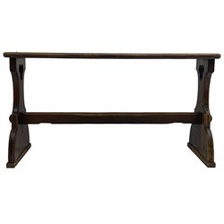  Late Victorian ecclesiastical pitch pine side table, rectangular bow-front top, on shaped end supports pierced with quatrefoils, united by pegged stretcher 