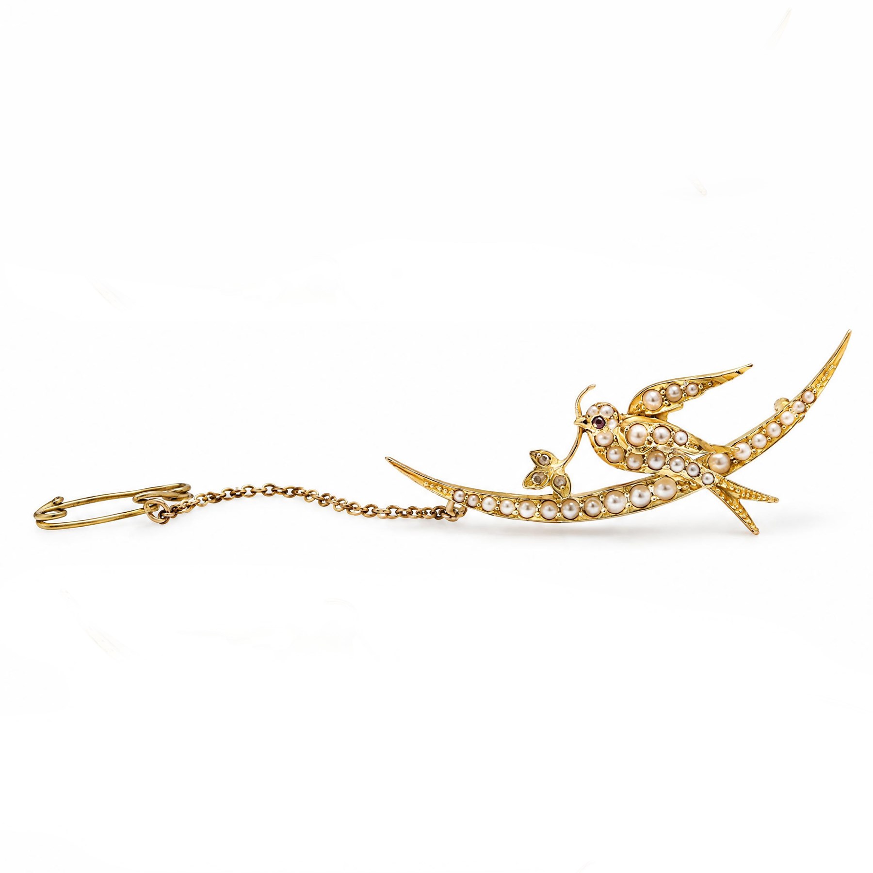 Early 20th century 15ct gold pearl and diamond swallow brooch, the split pearl set bird perched on a crescent moon, holding a leaf set with rose cut diamonds