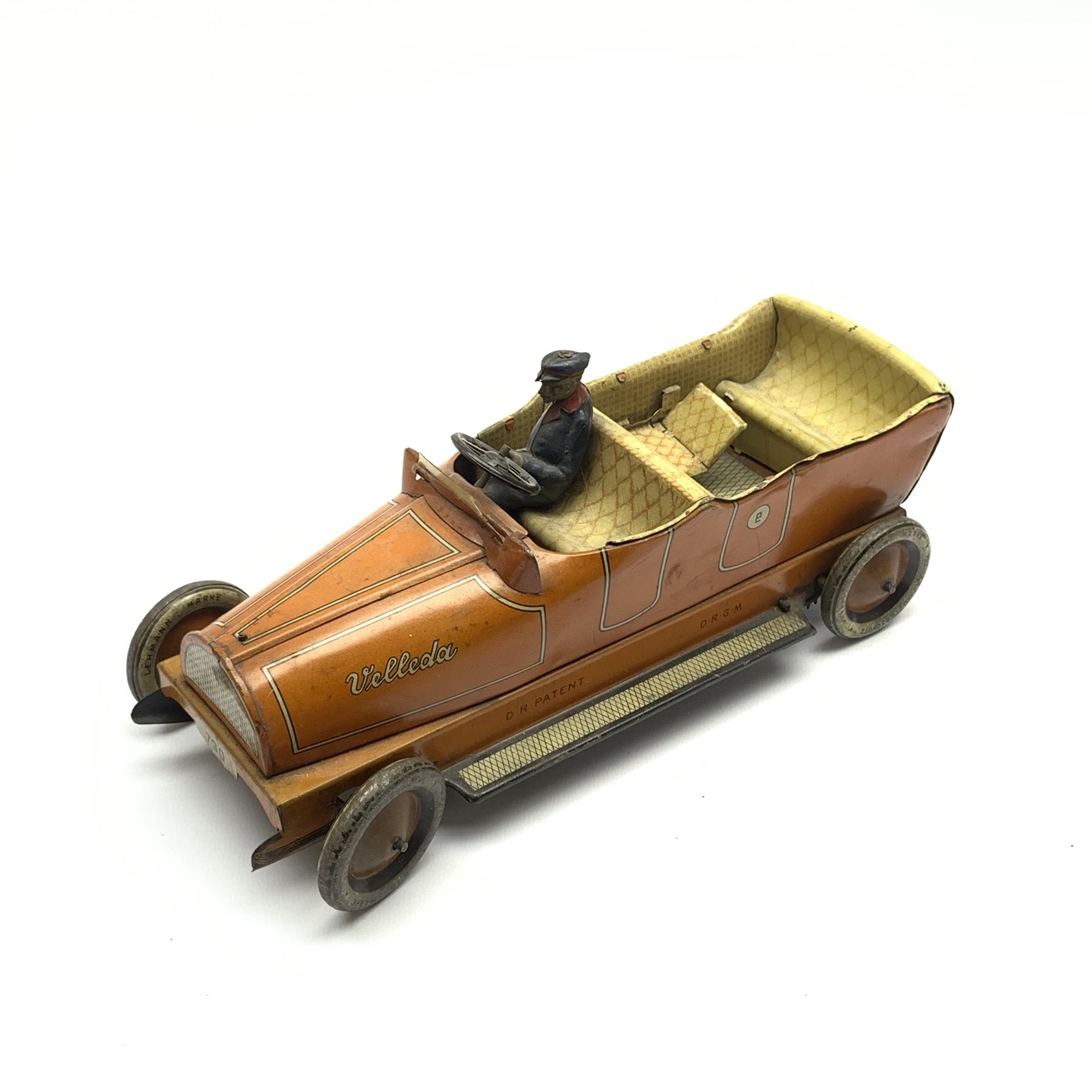 Early 20th century Lehmann clockwork tin-plate open top car with chauffeur, the bonnet inscribed 'Velleda', folding seats and bench seat to the back and integral key, various patent dates up to 1913, L25cm