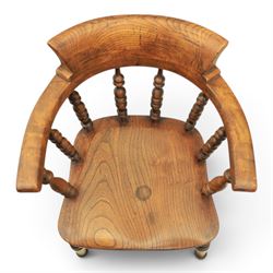 Early 20th century elm smoker's bow or captain's chair, elm dished seat raised on turned supports
