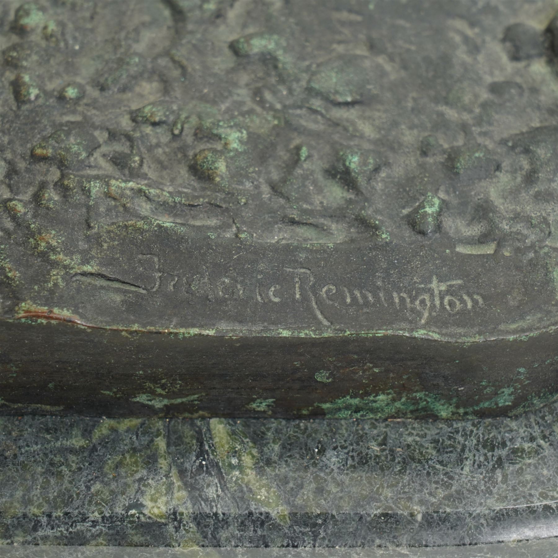 After Frederick Remington (American 1861-1909): 'Bronco Buster', limited edition bronze bearing signature and numbered 7/100, with foundry or ranch mark to horses backside of a triangle within circle, on green marble base, H56cm