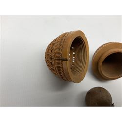 Three 19th century coquilla nut pomanders or flea catchers, each of egg shaped form with carved and pierced decoration and screw threaded join, largest example 6cm