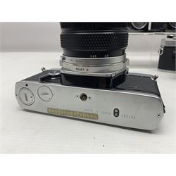 Four Olympus camera bodies, including Olympus OM10, serial no 20744269, with 'Olympus OM-System Zuiko Auto-S 50mm 1:1.8' lens serial no 3633644, Olympus OM-2 camera body serial no 460280 with 'Olympus OM-System G.Zuiko Auto-s 1:1.4 f=50mm' lens, serial no 729750, etc 