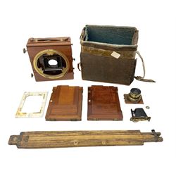 Ensign 'The Sanderson' folding plate camera in mahogany and lacquered brass, field model with canvas wrapped box, two mahogany photographic plates, 'Busch rapid Symmetrical F:8' lens,  and a wooden tripod 