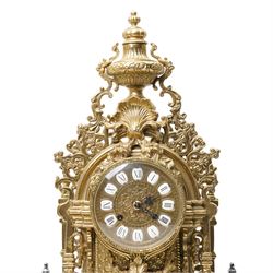 19th century design mantel clock, the brass dial with porcelain numerals, bell strike in brass case of rococo design with urn finial H60cm