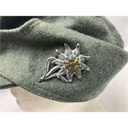 WW2 German Army M43 field cap with triangular cloth eagle and roundel badge and metal edelweiss badge for mountain troops; faintly stamped '5 VMF(?)'
