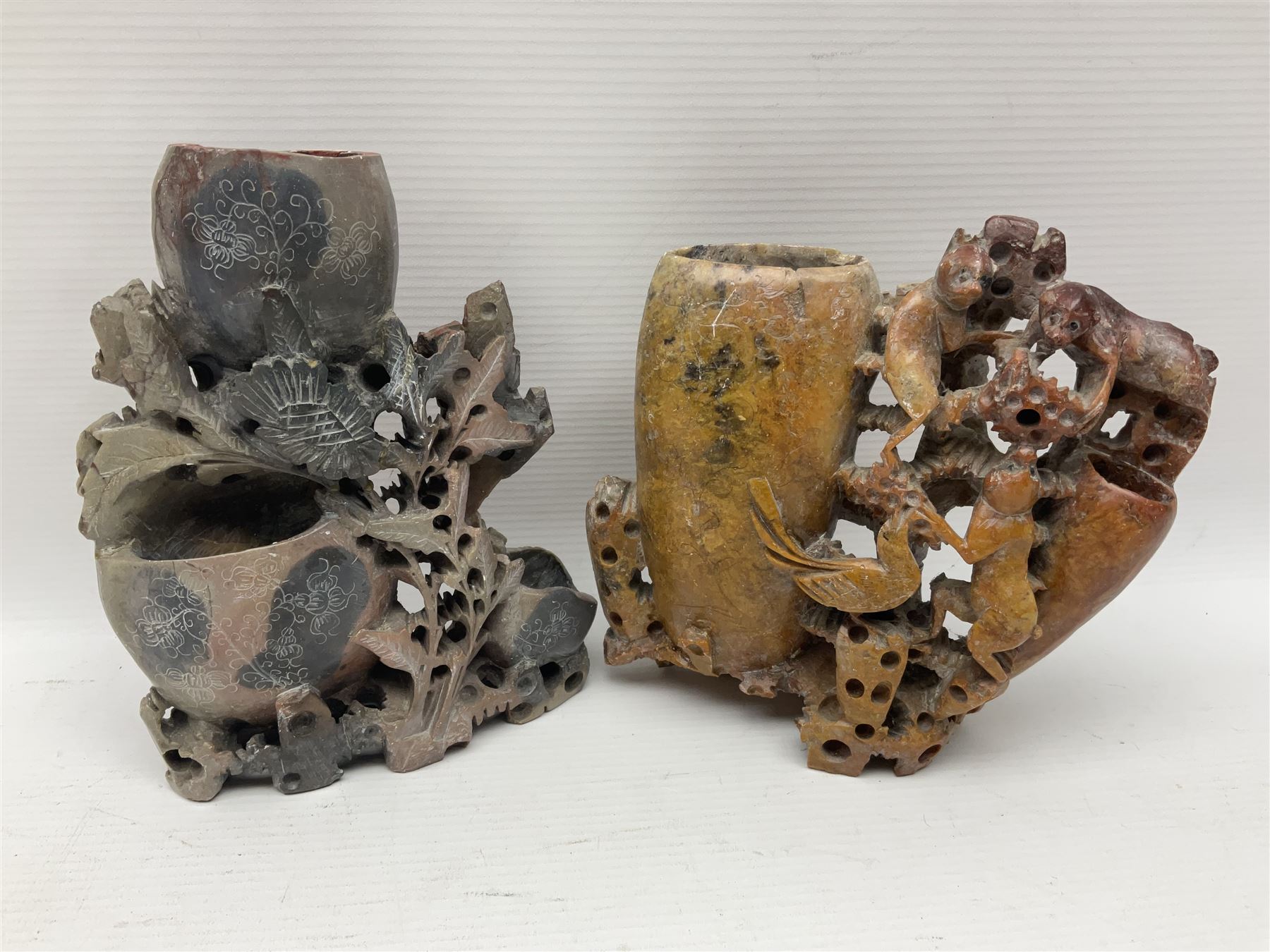 Carved soapstone puzzle ball, together with carved walnut shell and three soapstone brush pots, ball D12cm