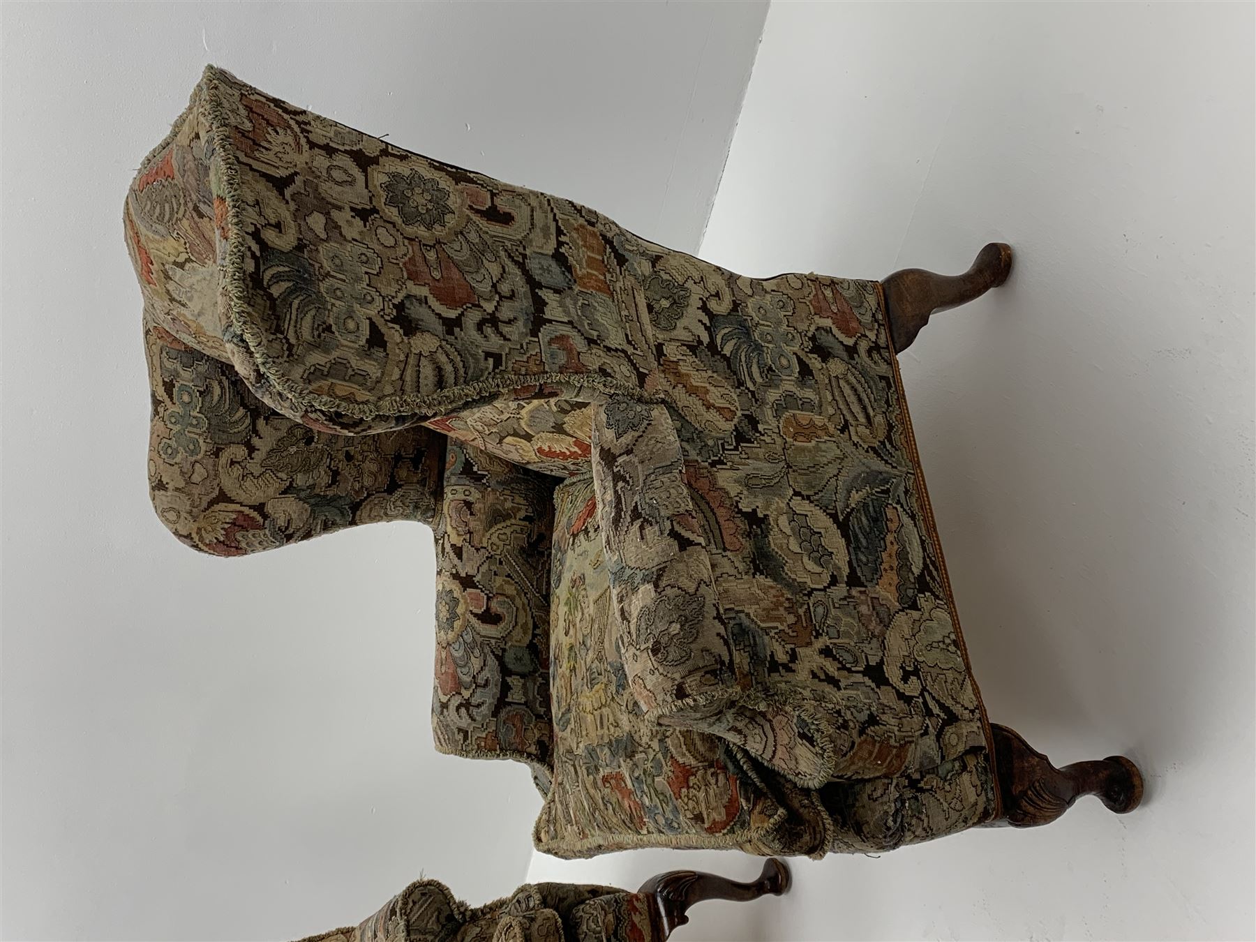 Matched pair early 20th century Queen Anne style wingback armchairs, walnut framed, sprung seats with seat cushions upholstered in needle work cover, shell carved cabriole front feet