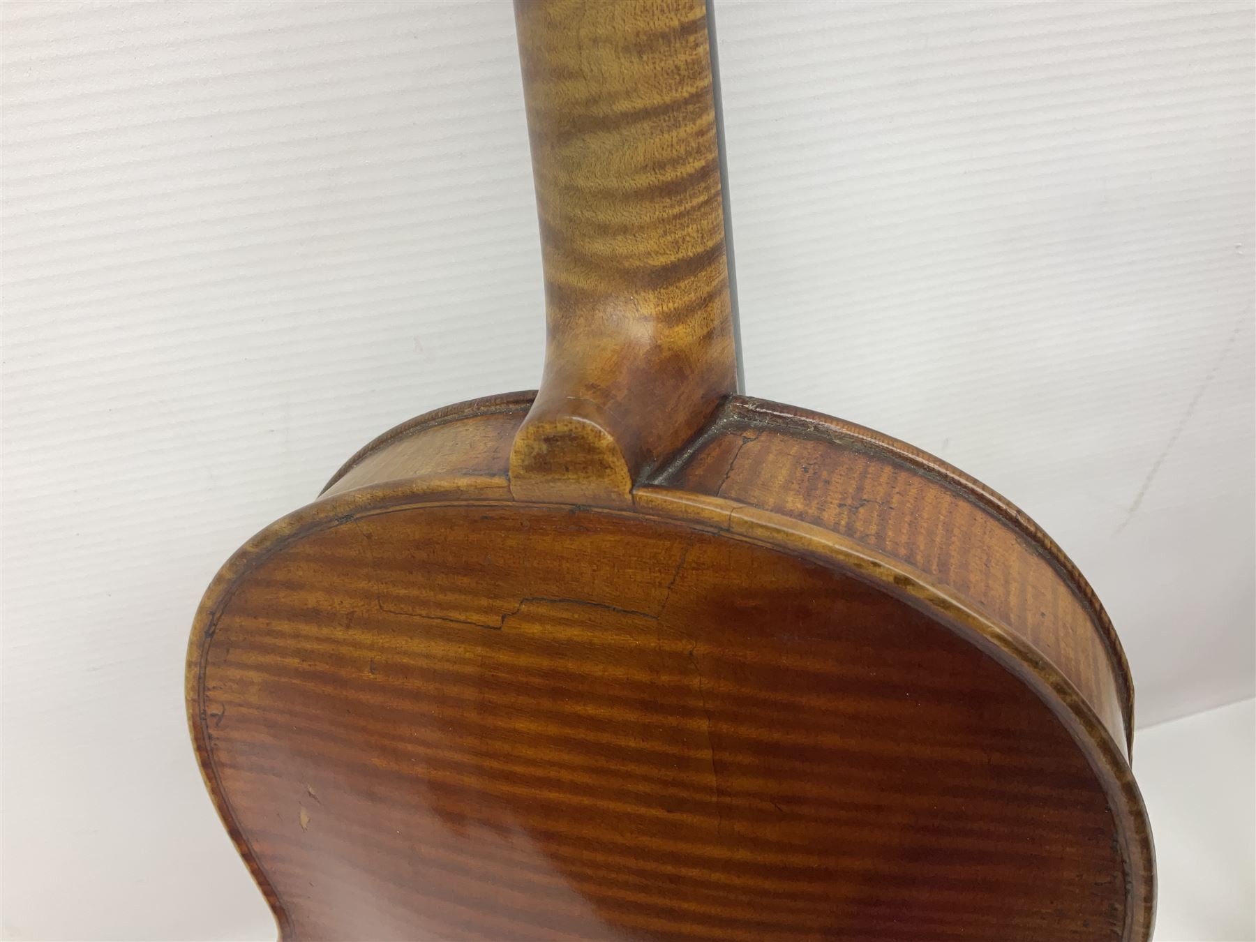 German trade violin in the Steiner style c1900 with 35.5cm two-piece maple back and ribs and spruce top L59cm overall; in fitted carrying case with two bows; and a Saxony violin with 35.5cm one-piece maple back and ribs and spruce top L58.5cm overall (2)