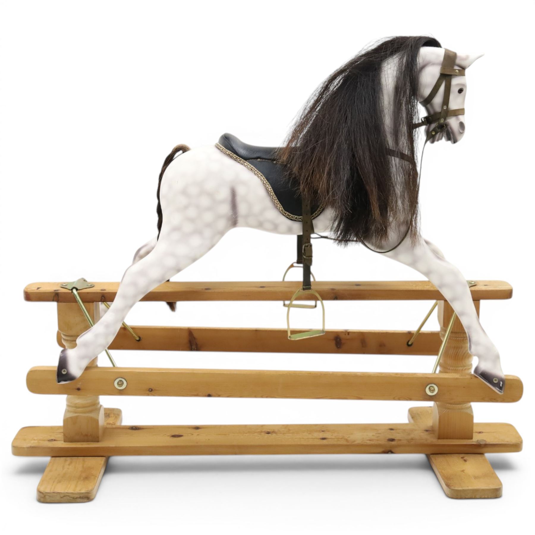 Late 20th century polychrome painted rocking horse, modelled in dapple grey finish with horse hair mane and tail, leather tack and saddle, stirrups, raised on a pine trestle base