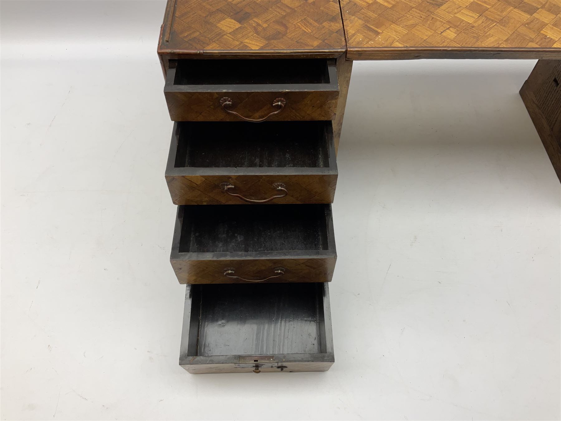 Japanese miniature kneehole desk decorated with parquetry inlay, the loose leaf top resting on one pedestal cabinet with four drawers, and another with hinged cupboard door opening to reveal two interior drawers above a lower drawer, H26cm, W68.5cm D24cm