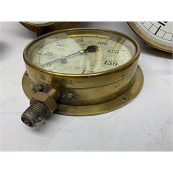 Four ship's brass cased pressure gauges by Dewrance London, Hopkinson Huddersfield, Bourdon and Bailey & Mackey Ltd; one with release valve; largest D29cm; and similar brass cased 'Water Level Below Surface' gauge by Thos. Matthews (Pumps) Ltd (5)