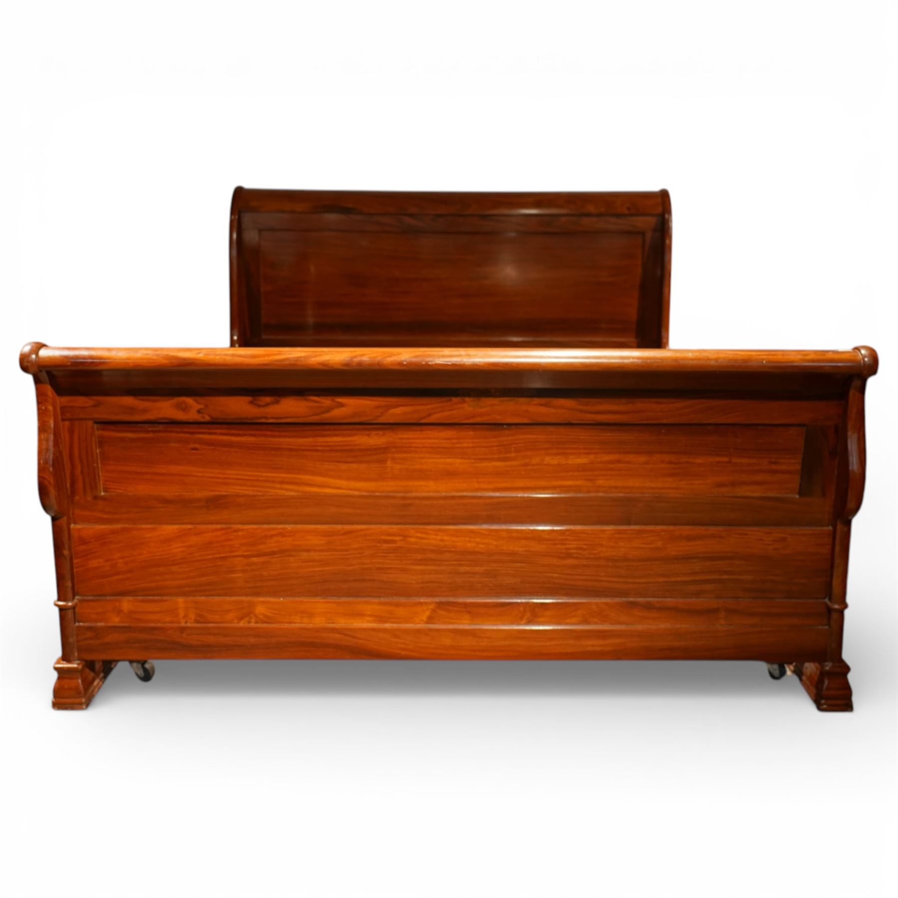 Victorian style mahogany super king sleigh bed with bases, shaped panelled headboard and footboard with scrolled ends, moulded side rails, raised on block supports with castors