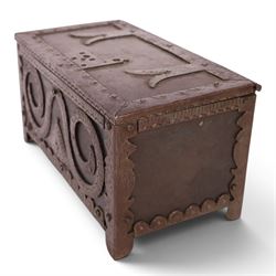 Late 19th/early 20th century vernacular iron box, the hinged cover and sides with applied strapwork decoration, the cover with applied church motif, H11.5cm W22cm D12cm