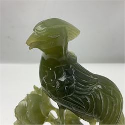Carved jade figure of a phoenix perched on a flowering branch, upon a wooden stand, with original box, H27cm
