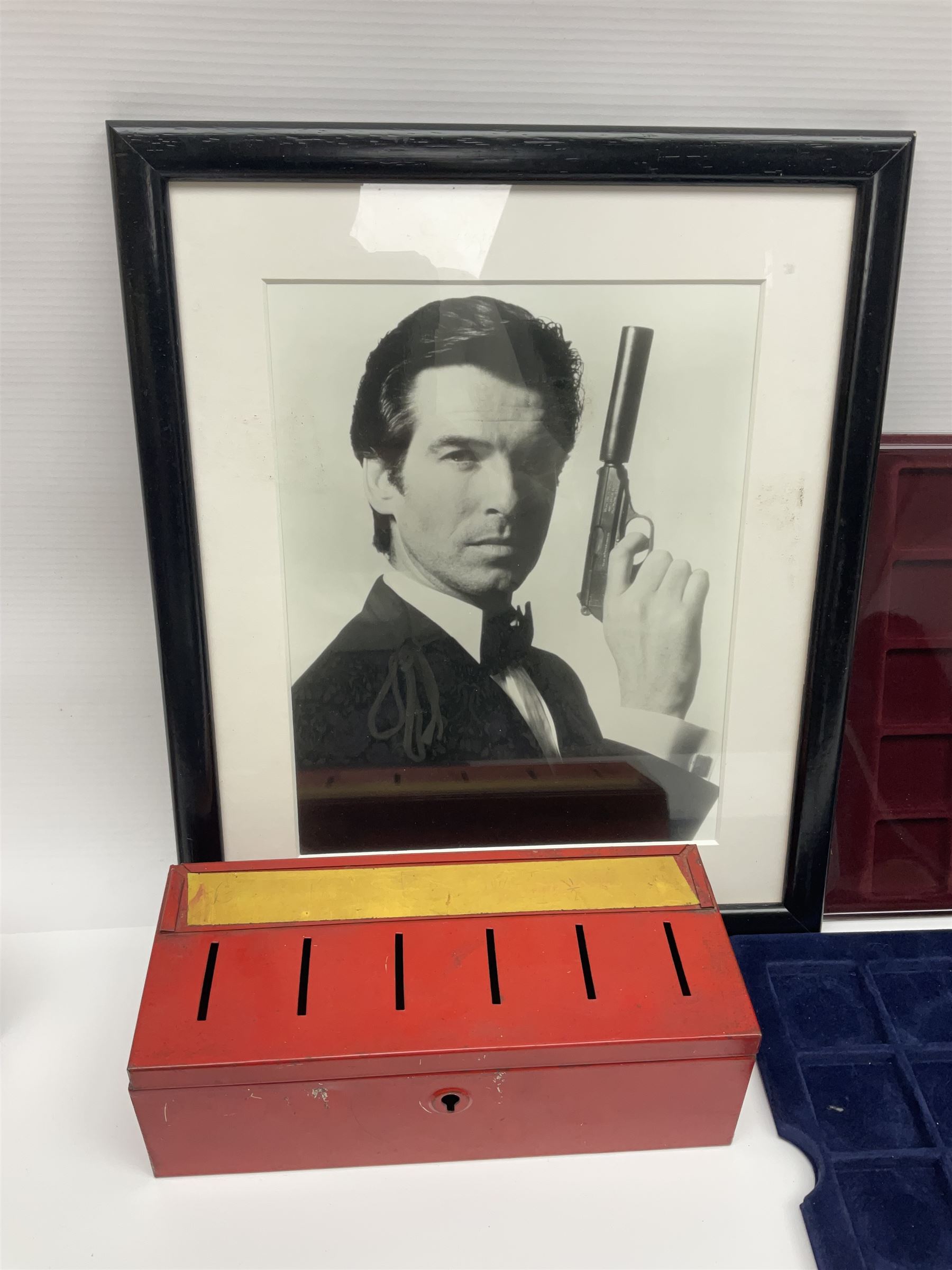 Pierce Brosnan framed picture, James Bond books, Corgi Tomorrow Never Dies BMW 750i model, small number of stamps, empty coin displays and other miscellaneous items