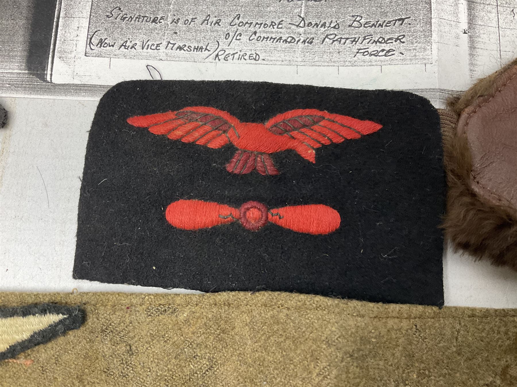 WW1 British Army Derby Scheme 1915 Attested armband; beret with East Yorkshire cap badge; pair of fur lined leather flying/motorcycle goggles; HMS Pembroke cap band; and small quantity of RNAS cloth and metal badges etc
