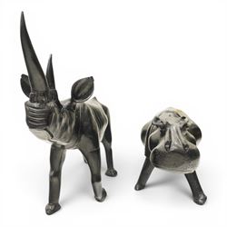 African carved hardwood ebonised figures of a rhinoceros and hippopotamus, each with stylised incised detail and polished dark finish, largest H 61cm, W 91cm)